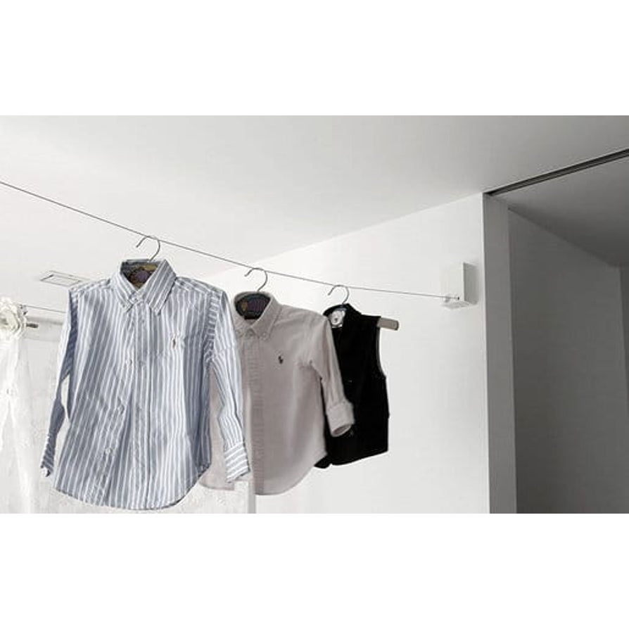 Retractable clothesline holding shirts indoors