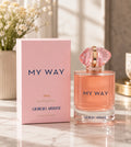 Giorgio Armani My Way Ylang Eau de Parfum bottle and its pink packaging box, styled on a marble surface with soft background lighting.