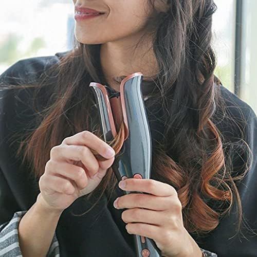 Woman using the automatic hair curler to style her long hair into waves