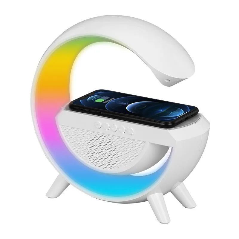 White LED wireless charging speaker with a colorful illuminated ring, shown with a smartphone charging on its base against a white background.
