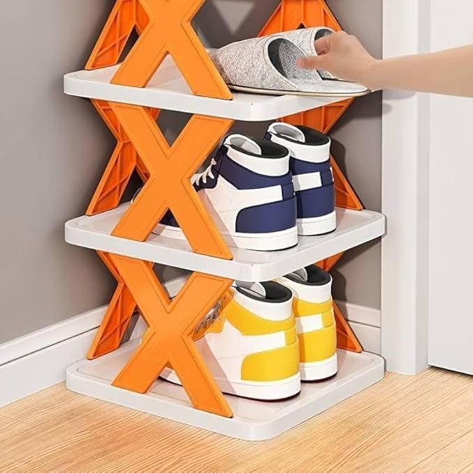 Orange and white X-shaped shoe rack holding sneakers, with a hand placing a shoe on the top shelf.